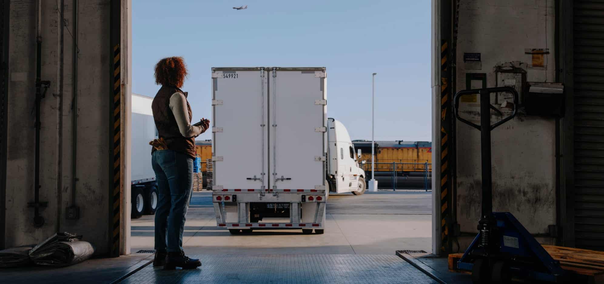 FROM_LOADING_BAY_A_0100_R4-1-1 woman watching truck from loading dock