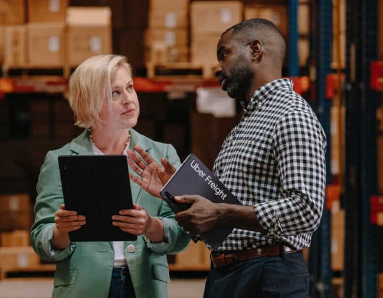 UF_SHIPPER_WALKTHROUGH_A_0059_R1-1 two people discussing something in warehouse