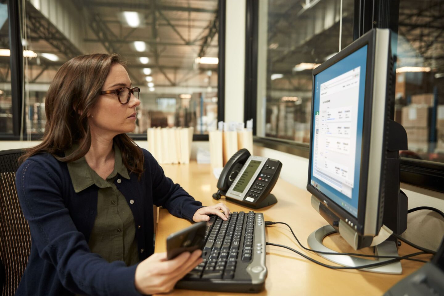 Freight-Quote-Hero woman looking at computer at desk